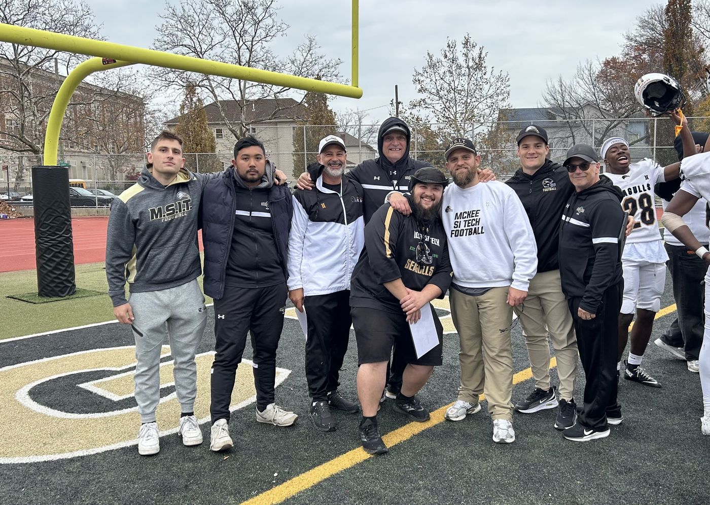 The McKee Staten Island Tech staff and players at midfield