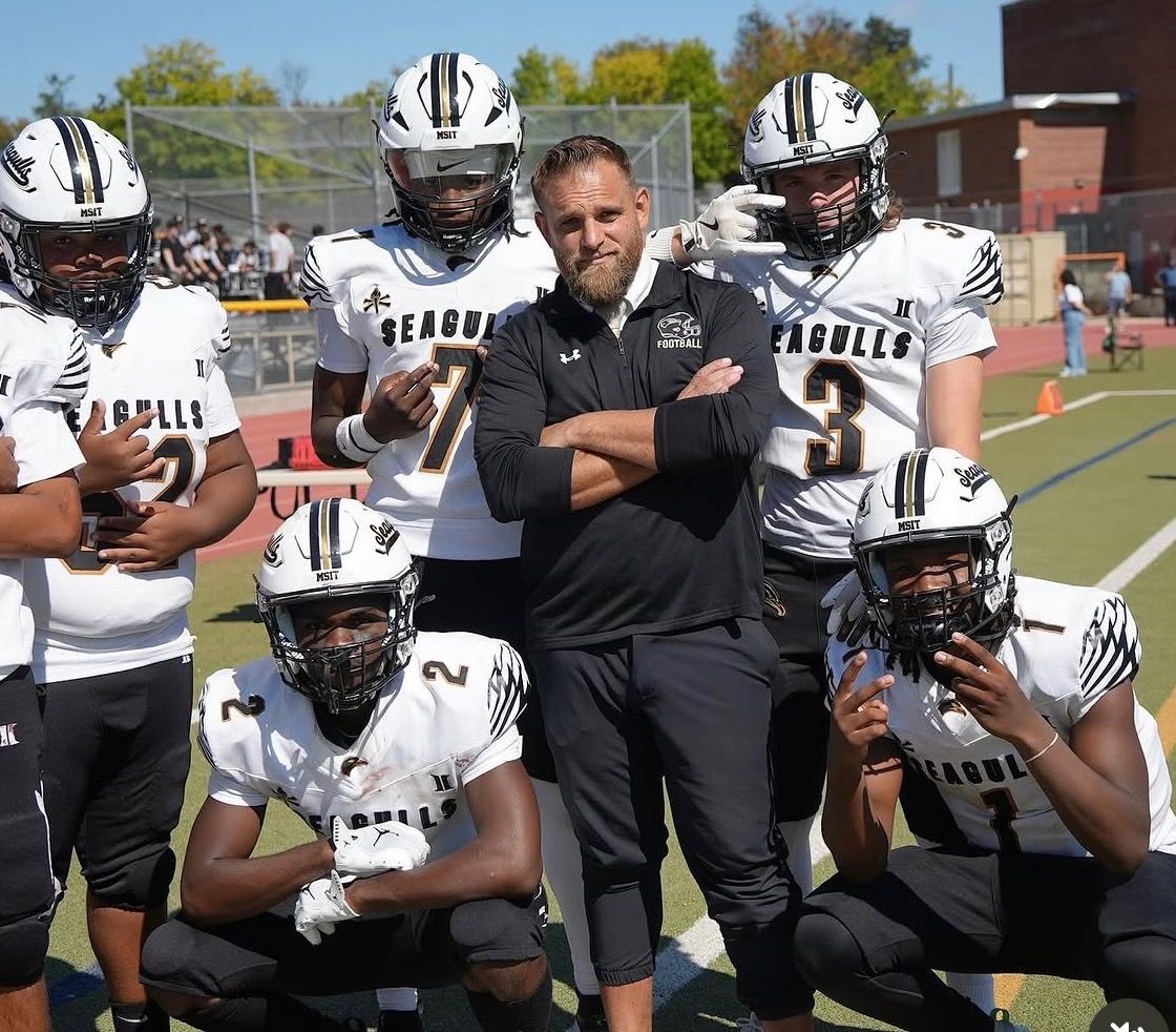 App with his players in uniform